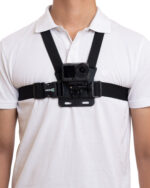 Person wearing a chest-mounted action camera on a black harness over a white shirt.
