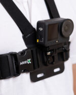 Chest-mounted DJI action camera attached to a black harness with an ARIES label visible on the strap.