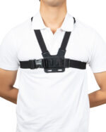 Person wearing a black chest harness with buckles over a white shirt, shown from the neck to mid-torso