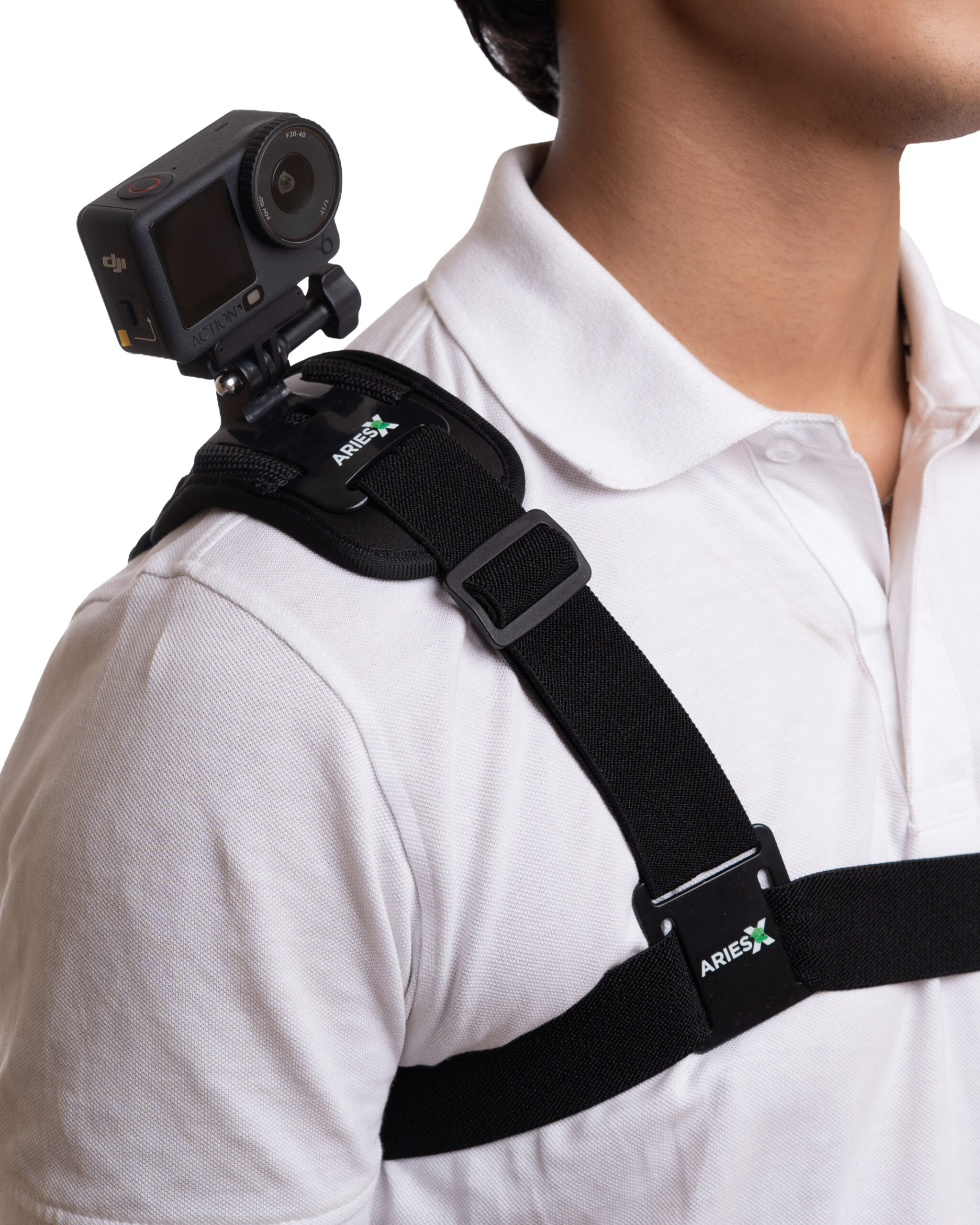 AX-WU-STRP-SAC AriesX SecureGrip Shoulder Camera Strap 1 - StudioBackdrops.com Close-up of a person wearing a black chest mount with an action camera attached, ARIES logo on the strap, white shirt visible.