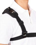 Close-up of a black shoulder strap with a metal buckle and ARIES logo on a white shirt.