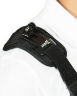 Close-up of a black plastic buckle and strap on white fabric, likely part of a backpack or bag.