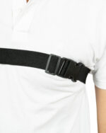 Close-up of a person’s waist wearing a white shirt with a black belt and buckle.