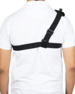 Back view of a person wearing a white shirt with a black crossbody strap and buckle across the chest.