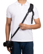 Person wearing a white polo with a camera slung over the shoulder on a black strap across the chest.