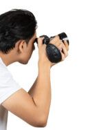 Person holding a DSLR camera up to their eye, about to take a photo.